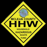 McLean County Household Hazardous Waste logo on a bright yellow sign with a black background.