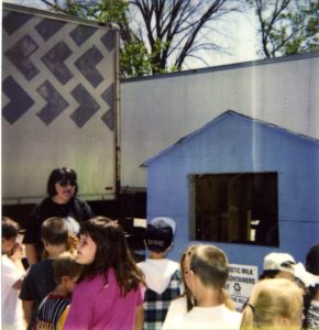 A group of children watching a workshop on recycling hosted by the Ecology Action Center.