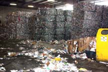 In the final step, recyclable materials are compacted and baled. The bales are stacked, waiting to be loaded into semi-trailers.