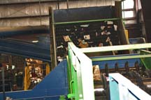 Flat paper goes over the incline while other objects slip backwards onto another conveyor belt for sorting.