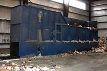 All of the waste is dropped into a drum feeder, which flattens the pile of waste and outputs a consistent stream of materials. 