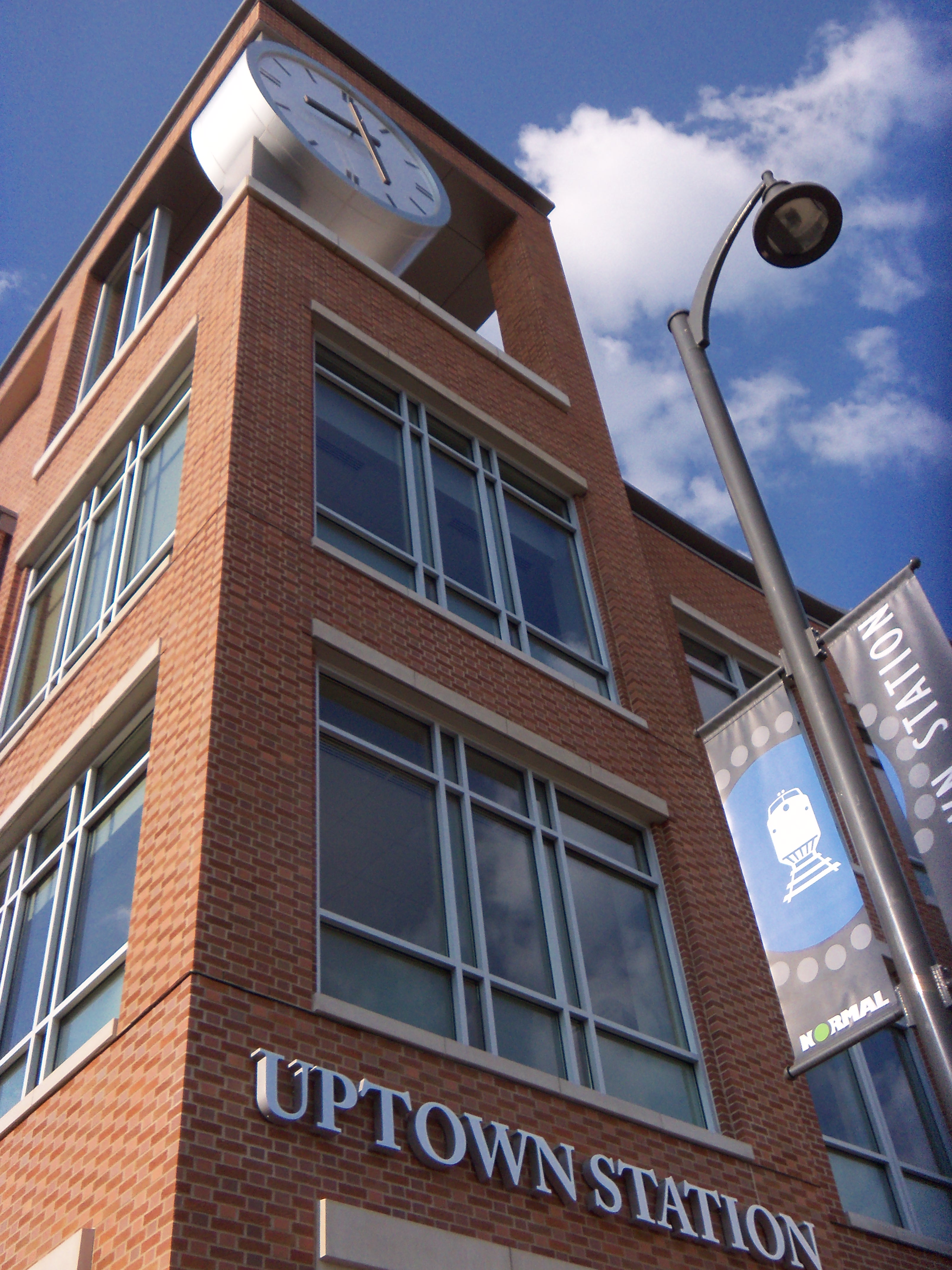 The clock and sign of Uptown Station in Uptown Normal.