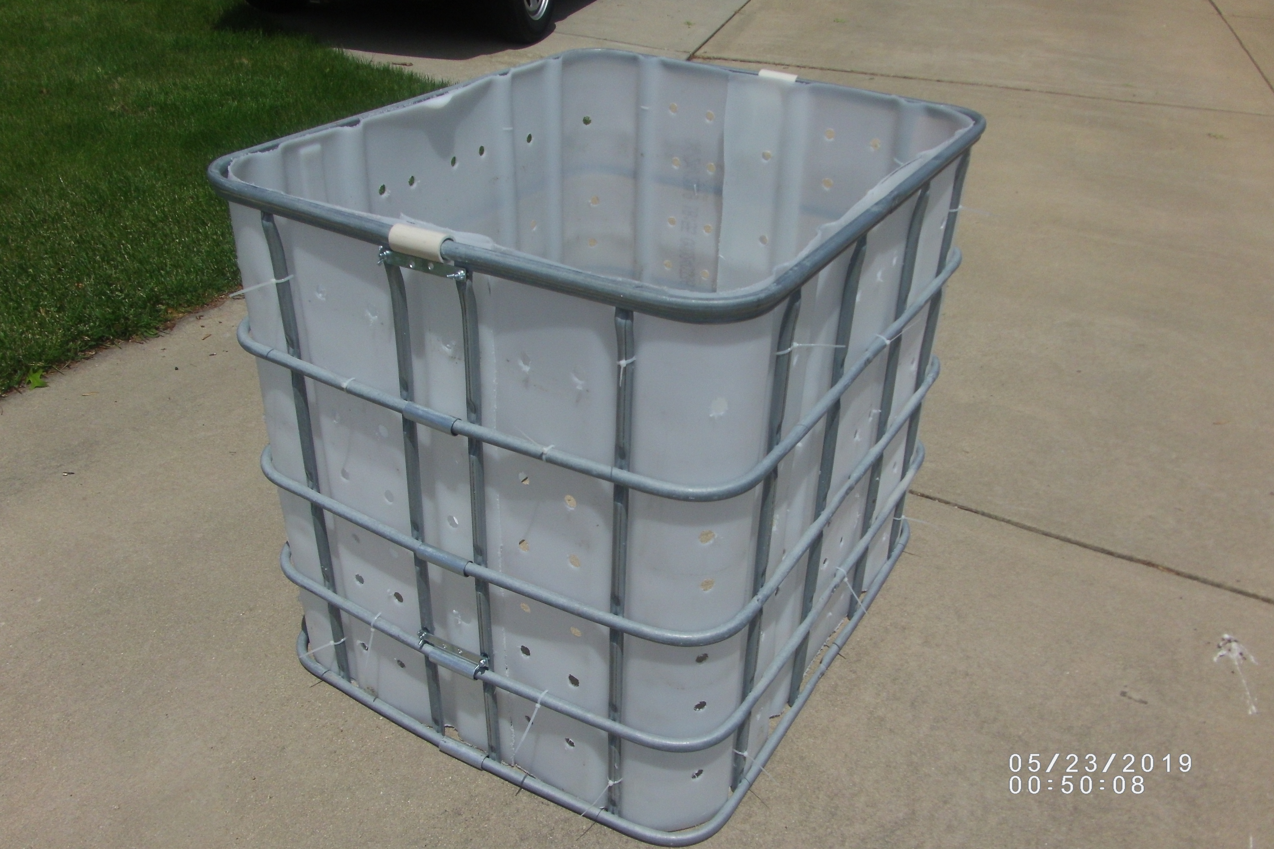 A completed compost bin with a metal frame.