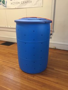 Blue compost bin made from a repurposed 55 gallon barrel