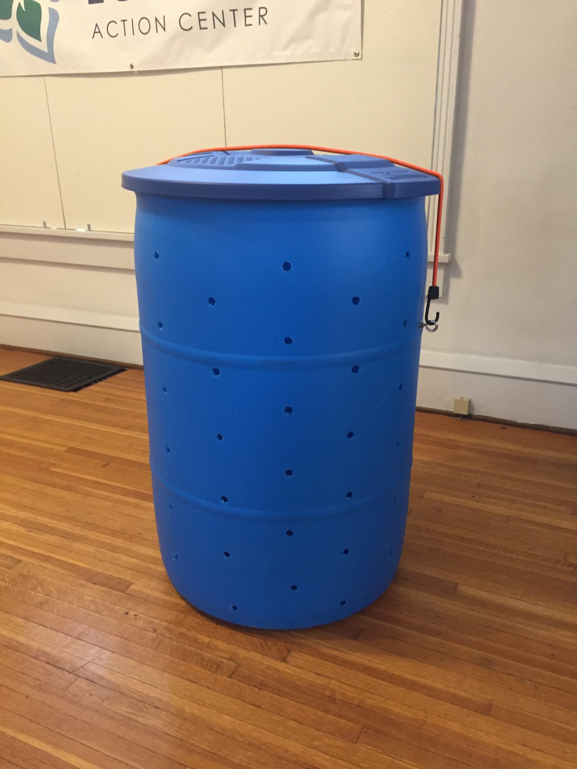 Blue compost bin made from a repurposed 55 gallon barrel