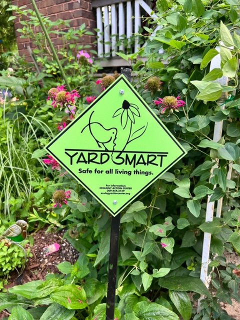 a green, diamond shaped yard smart sign